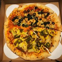 One side with vegan chicken and black olives, the other with banana peppers, vegan beef, artichokes and jalapeños.  at Chattanooga Pizza Co in Chattanooga