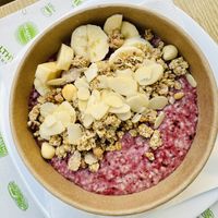 Porridge with forest fruits and banana  at Healthy Harmony Piraeus in Piraeus