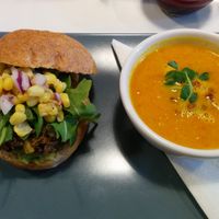 California Burger topped with corn salsa and arugula, with carrot ginger soup of the day at Sprout in Nelson