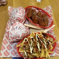 Two burgers, Korean chicken ribs and doner loaded fries   at Temple of Seitan - Camden in North West London