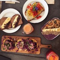 Almond butter toast, scrambled tofu & dill/cashew cheese toast, blueberry muffin bowl, selection of vegan tacos, 2 juices at Eight - The Health Lounge in Lisbon