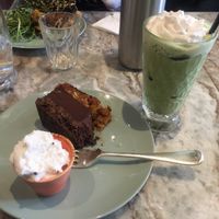 Iced matcha latte and vegan chocolate nut slice with coconut cream at Dough Lover in Brighton