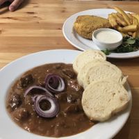 Beer goulash and vegan fried cheese served with tatar sauce  at Střecha in Prague