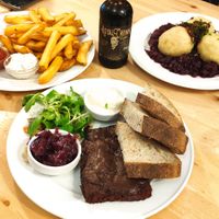 Ribs in plum sauce, fries with tris of dips, and dumplings on red cabbage at Střecha in Prague
