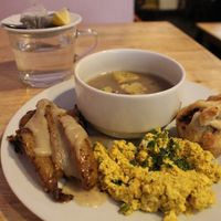 Excellent onion soup, puff pastry with, I guess, beans, scrambled tofu with turmeric, roasted potatoes with garlic gravy, and a small piece of chocolate with lupin, black tea. at Střecha in Prague