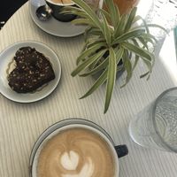 Coffee with vegan milk and a vegan brownie at Cajnica Vanilla in Koper