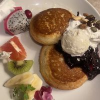 Pancakes with fruits, ice cream, cream and black currant sauce + some nuts and seeds.  at AIN SOPH.Journey in Kyoto