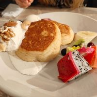 Fluffy Japanese pancakes with fresh fruit and whipped cream at AIN SOPH.Journey in Kyoto