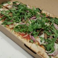 Multigrain dough with mushrooms, red onion, spinach, arugula, and vegan cheese at Zablong in Cincinnati