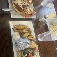 Vegan poutine and Philly jackfruit, Greek gyro wrap with roast potatoes and Greek salad.  at Hometown Sports Grill in Ottawa