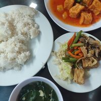 Rice plate (front) and tomato tofu (back) at Huyen Trang in Da Nang
