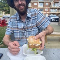 Ian with his Crispy Jerk sandwich. at Stir It Up in Charlottetown
