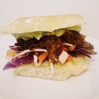 BBQ pulled jackfruit on a bed of mango slaw - topped with a creamy avocado guac! All served up on an organic ciabatta bun from @breadworkspei at Stir It Up in Charlottetown