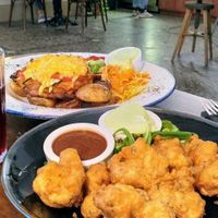 Front: buffalo cauliflower. Back: schnitzel at Mazā Terapija in Riga