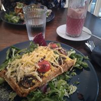 Breakfast waffle (closest) and carrot salmon waffle with raspberry chai latte at Mazā Terapija in Riga