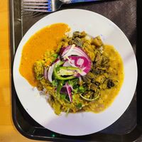 Rice bowl with half lentils and various toppinggs  at Bridges Nepali Cuisine - Northside in Cincinnati