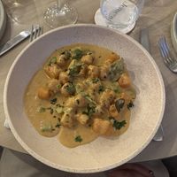 Gnocchi with Jensens red curry sauce, fresh herbs and coconut crunch (GF)  at Jensens in Kareela