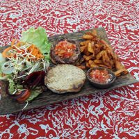 Burger with sweet potato fries and side salad at Nourish Restaurant in 
