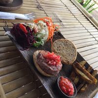 spicy burger with fries at Nourish Restaurant in 