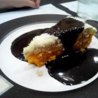Coconut and carrot cake served with a chocolate sauce. at Garibolo in Bilbao