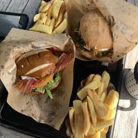 Foreground is their new Bavarian Burger with chunky chips, the background is the Cheeseburger, both perfect when time is of the essence!   at Swing Kitchen - Währinger Straße in Vienna