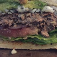 Close up of beyond burger with shredded vegan cheese at The Copper Vault in Springfield