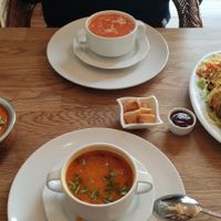 Vegetarian paneer tikka (right), vegan tofu with peas and tomato sauce (left) and two soups - vegetarian & vegan at Bhajan Cafe in Krakow