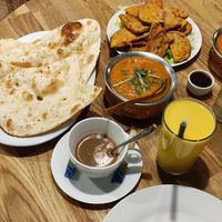 Vegan mango lassie, chai, naan and sabji kofta plus baked aubergine at Bhajan Cafe in Krakow