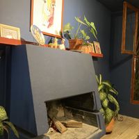 Fire place with lots of llama imagery   at De La Llama in Quito