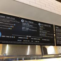 Menu at Amsterdam Falafel- blue v for vegan at Flagship Commons in Omaha