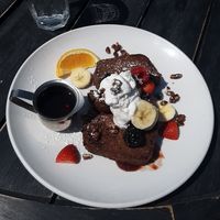 [Vegan] Banana Bread French Toast w/ berry jam, berries, whipped coconut cream, & candied pecans at Saddle Creek Breakfast Club in Omaha
