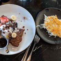 Banana bread french toast with a side of hashbrowns at Saddle Creek Breakfast Club in Omaha