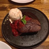 Warm brownie with red wine compote and nutty ice cream   at Polpetta in New Plymouth