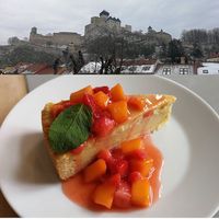 Mango-strawberry cake with a beautiful view on Trencin’s castle. at Roots in Trencin