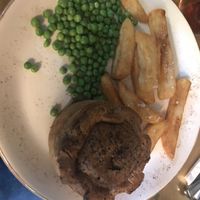 Woodland mushroom and ale pie with peas and triple-cooked chips.  at The Eagle in Cambridge