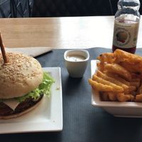 Sesame bun, lentil patty, organic mayonnaise, roasted peanuts and popped carrots. Apple and Cherry juice. Side is potato wafers.  at H&K's - Vlaamsesteenweg in Brussels