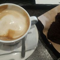 Vegan cappuchino, got a free piece of vegan choco cake with it!! at Almond Cafe in Ioannina