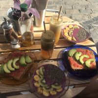 Breakfast: fresh apple chia juice, fresh orange juice, toast with tomato and avocado, açai bowl!  at NicPic in Malaga