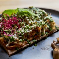 raw vegan pizza at Les Mauvaises Herbes in Lyon
