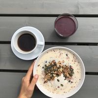 Millet porridge with stewed rhubarb compote and a mixed berry smoothie, both delicious! at Jord in Malmo