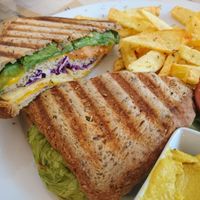 Vegan sandwich with vegan cheese, tempeh. Chips on the side at Bar Ecologico Gaia in Sevilla