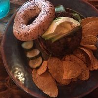Vegan burger with bagel and sweet potato chips at Bare Roots Farmacy in Columbus
