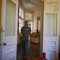 The restaurant is on the first floor of an old building with heigh ceilings and doors at Govindas Hare Krishna in Valparaiso