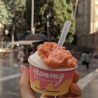 Creamy vanilla and fresh strawberry balls of ice cream at Yummy Helados in Malaga