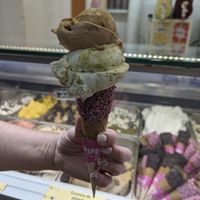 Medium waffle cone with pink sprinkles, pistachio (bottom) and caramel (top) at Yummy Helados in Malaga