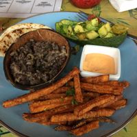 Black bean burrito, avocado, sweet potato french fries. at Toko Trash in Rotterdam