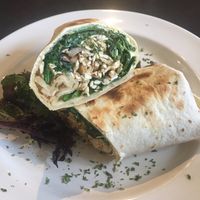 Tofu and mushroom scramble with spinach in a wrap at Rustic Cosmo Cafe in Toronto