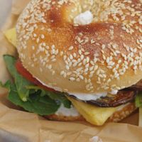 bagel sando on a sesame bagel bun with cream cheese at Soulshine in San Diego