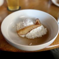 The vegan rice pudding “dessert” option, topped with cooked apple slices and coconut-based vanilla ice-cream.   at New Sydney Hotel in Hobart