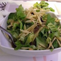 Salad with lettuce, apple, seeds, dried grapes, balsamic vinegar. at Asian House in Thessaloniki